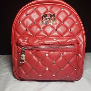 Badgley Mischka mini quilted backpack with gold in color studs.